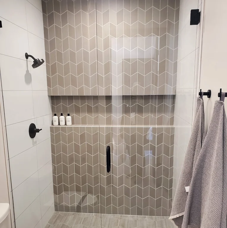 Grey tile in a modern shower remodel by Barrett Floors