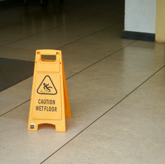 Clean Commercial Tile Floor with Caution Sign