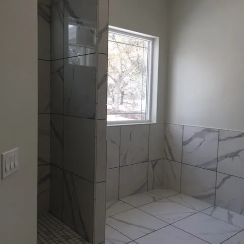 Marble shower and floors by Barrett Floors