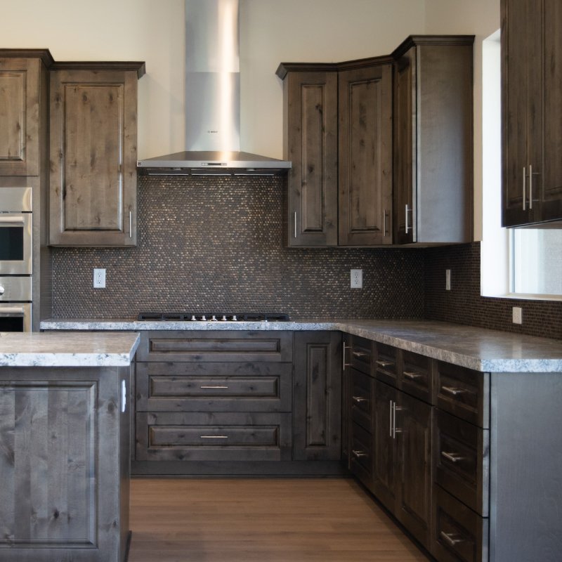 Dark Wood Cabinets and custom tile backsplash in a new Prescott, AZ home