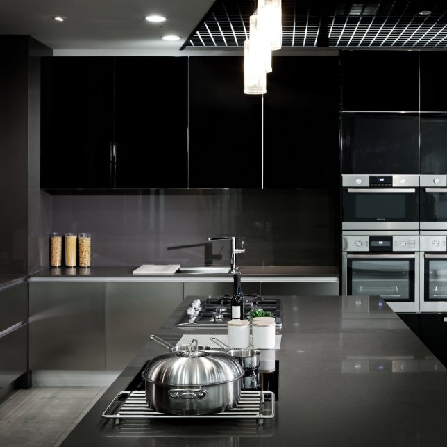 Dark and modern kitchen with quartz countertop and backsplash installed in Slate Grey by Arizona Tile